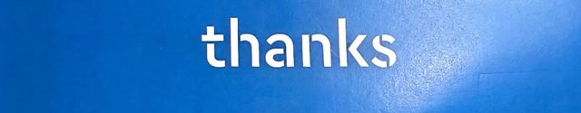 A blue thank-you card with the word &lsquo;thanks&rsquo; printed across it.
